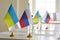 Table with flags of Russia and Ukraine in conference room after negotiation meeting