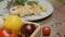 Table with fresh vegetables, spices and chicken roll with spinach