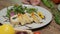 Table with fresh vegetables, spices and chicken roll with spinach