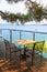 Table and iron chairs on terrace with sea view (Greece)