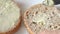 A table knife spreading soft butter over the surface of a grainy, porous slice of bread. Close-up