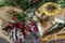 On the table laid Christmas decorations. Cake, cinnamon, star anise, pieces of dried lemons, pine branch.