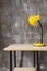 table lamp at wooden table near concrete grey wall background