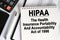 On the table lies a smartphone, a calculator and a notebook with the inscription- HIPAA