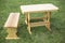 Table made of wood on green grass. Bench and table. Empty picnic area