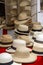 Table with many old fashioned traditional straw hats