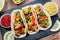 Table with meat tacos, nachos with sauce, guacamole, Cinco de Mayo celebration party. Appetizers and traditional mexican dishes