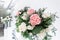 The table of the newlyweds. Small flower arrangements in ball glass vases. Interior of restaurant for wedding dinner