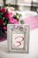 Table number in silver frame with a numeral three