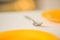 Table with orange plates and fork closeup, ready for food time