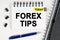 On the table is a pen and a notebook with inscriptions - Today and FOREX TIPS