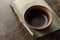 Table. A piece of brown paper and an empty bowl on a scratched wooden surface