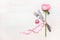 Table place setting : rose flower, cutlery and ribbon on light background, top view