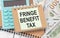 On the table are reports, a magnifying glass, a calculator, a pen, and a white notebook with the text FBT Fringe Benefit Tax.