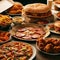 Table scene with large variety of take out and fast foods. Hamburgers, pizza, fried chicken and sides