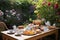 table set for afternoon tea, with delicate cups, pastries and rose garden in the background