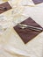 table set with beige tablecloth and brown napkins, glasses cutlery and ready-made condiments in an Italian restaurant