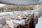 Table set for breakfast on the rear deck of a luxury private yacht, cruising the mediterranean sea and docked in front of Lipari