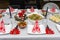 A table set before dinner for Christmas in Poland, visible baked fish fillets in cream-mushroom sauce and herring in oil.