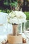Table set for an event party or wedding reception banquet. Winter bridal bouquet of white carnations, peony, roses