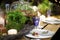 Table set for an event party or wedding reception in rustic or scandinavian style decorated moss and fern. Fashionable table set