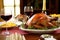 a table set for a holiday meal featuring a roast turkey