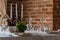 Table set in a luxurious restaurant with brick wall background