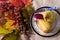 Table set with pears on pretty antique plate and knife, with bunch of colourful autumn leaves