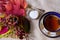 Table set with pretty antique porcelain teacup, tiny sugar bowl and spoon, with bunch of colourful autumn leaves