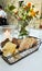 Table set with three different kind of bread and flowers and candle turned on