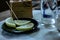 Table set up in a restaurant. narrow frame with objects that are usually found in a restaurant such as beverage glasses etc.