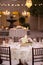 Table settiings for a large wedding ceremony in an outdoor patio area
