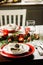 Table setting for celebration Christmas and New Year Holidays. Festive table in classic red and green at home with rustic details