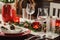 Table setting for celebration Christmas and New Year Holidays. Festive table in classic red and green at home with rustic details