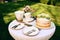 Table setting, ceramic teapot, teacups, cake