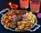 A table setting of Diwali lamp with silver tray full of Indian sweets