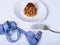 Table setting with fork, measuring tape, back of cake on a plate on a white background, close-up, copy space