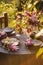 Table Setting in Garden on Sunset Light. Table decorated with magnolia flowers under magnolia tree.