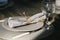 Table setting. One grey plate. Knife and fork. Old fashioned wine glass. Rustic napkin. Wooden table. Selective focus