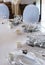 Table setting: plates, forks, knives, knotted napkin, glasses, small gift box