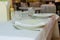 Table setting. Restaurant interior. Clean plates, glasses and cutlery on a white tablecloth. Preparing for guest service