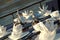 A table setting with silver teapot, cookie plate and accesories on the luxury big yacht in morning light.