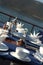 A table setting with silver teapot and silver cookie plate for breakfast on the luxury wooden big yacht.