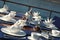 A table setting with silver teapot and silver cookie plate for breakfast on the luxury wooden big yacht.