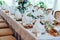 Table setting. Table served for wedding banquet, close up view. White napkin on a white empty plate on dining table