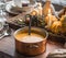 Table setting for Thanksgiving. Big cooper pan with orange pumpkin soup.