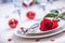 Table setting for valentines or wedding day with red roses. Romantic table setting for two with roses plates cups and cutlery