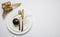 Table setting, xmas, new year. Gold cutlery on white set of dishes, white background