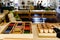 Table and shelving with montessori material, colored items and wooden cylinders to study geometry in the classroom