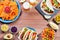 Table with tacos, mango salsa, nachos with sauce, guacamole, lemon beer for Cinco de Mayo celebration party. Appetizers and